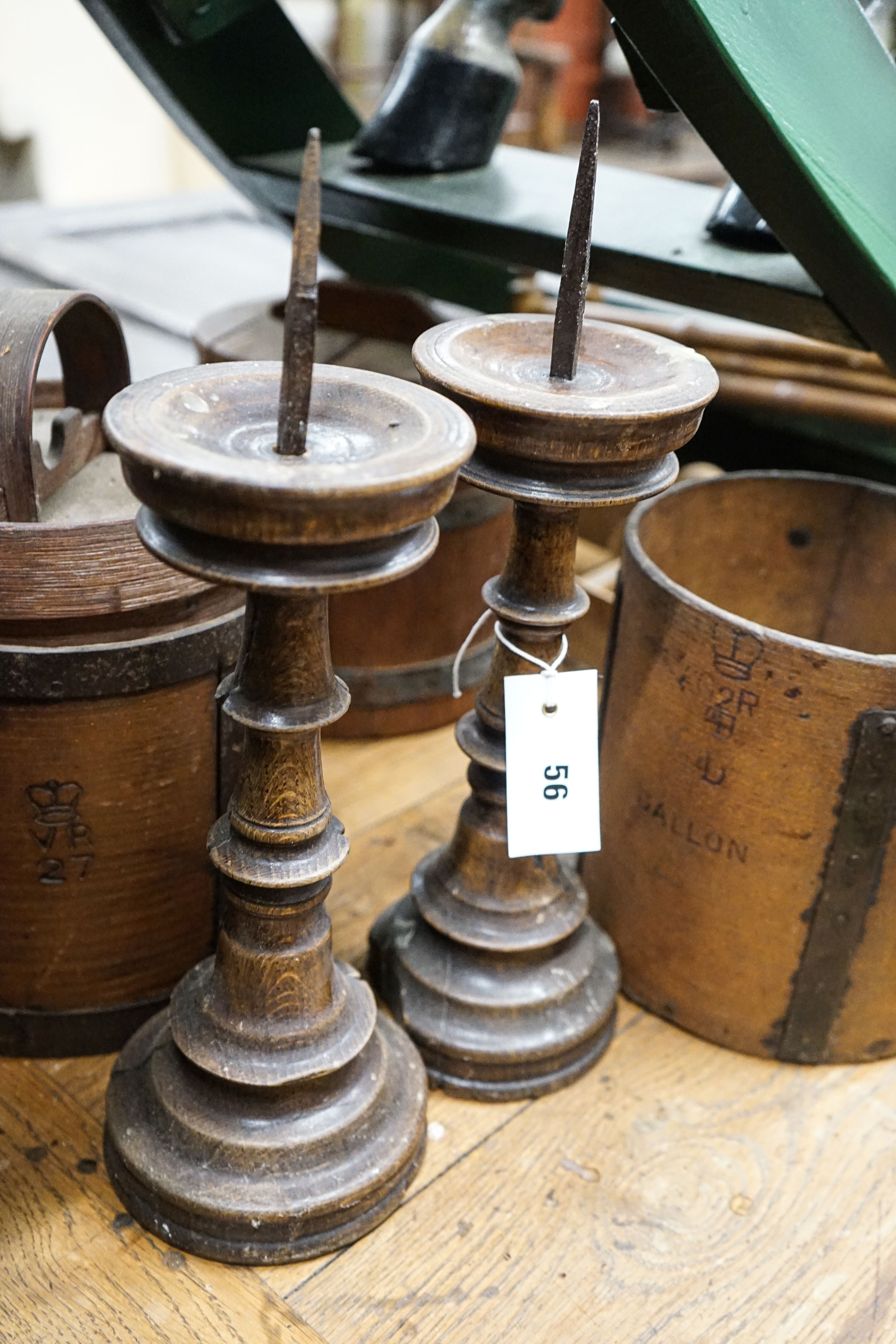 Six assorted treen measures and butter pails, a pair of pricket candlesticks, height 37cm and three faux bamboo coat hooks